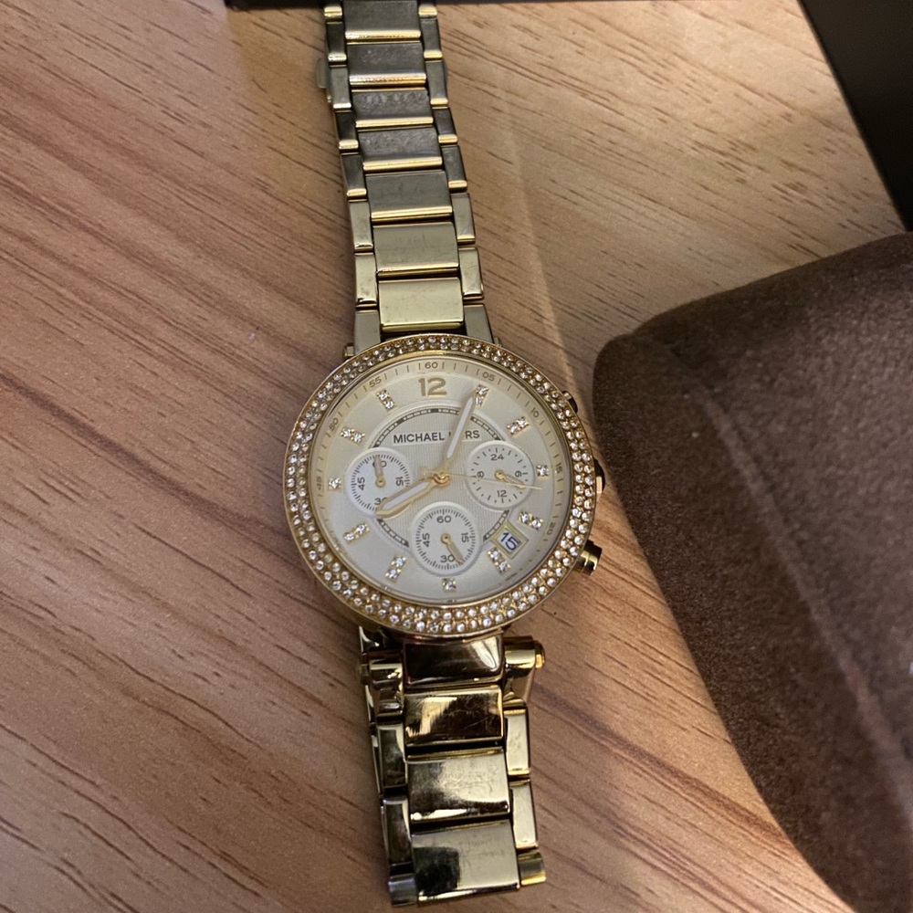Gold tone stainless steel bracelet watch come with leather case